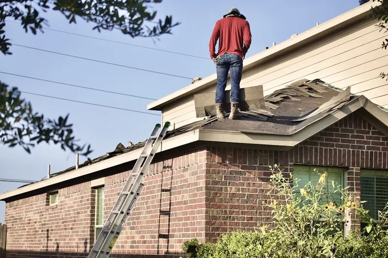 Professional roofer working on a residential roof in Union Village